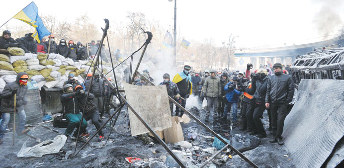 GOING MEDIAEVAL: Anti-government protesters prepare to use an improvised slingshot to lob a stone during clashes with police in Kiev.