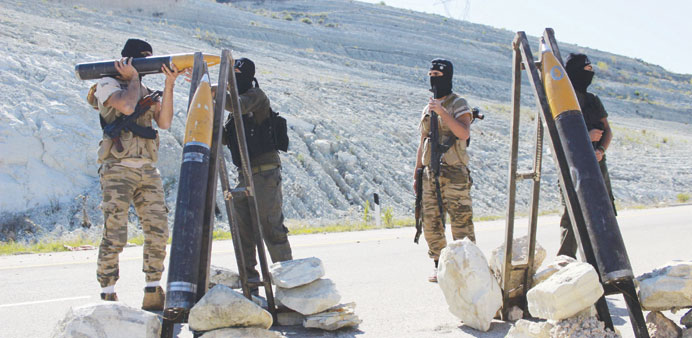Free Syrian Army fighters prepare rockets before launching them towards regime forces in the Jabal  al-Akrad area of Syriau2019s northwestern Latakia prov