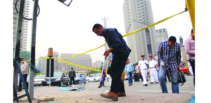 Security officials inspect the site of the bomb attack in Cairo yesterday. 