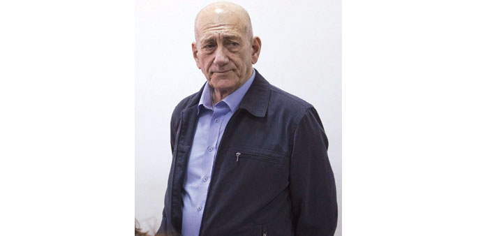 Olmert stands in the Jerusalem district court yesterday.