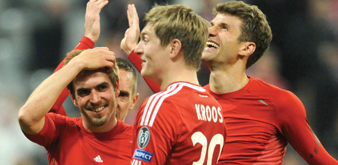 (From left) Bayern Munich players Philipp Lahm, Toni Kroos and Thomas Muller jubilate after beating Manchester United in the UEFA Champions League qua