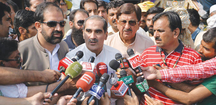 Pakistan Muslim League Nawaz senior leader Khawaja Saad Rafiq (centre) is flanked by representatives of Tahirul Qadri, Raheeq Abbasi (left) and Khurra