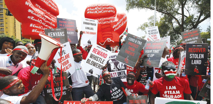 Kenyans hold placards during a protest in Nairobi yesterday, dubbed KnockOutCorruption, against what organisers say is corruption in government.