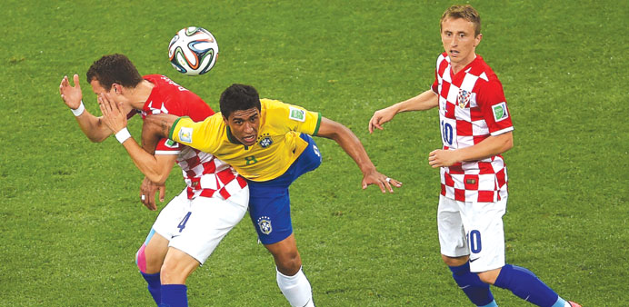 Brazilu2019s midfielder Paulinho (C) fighting for the ball with Croatiau2019s Ivan Perisic (L) and Luka Modric (R) during their Group A match on Thursday.