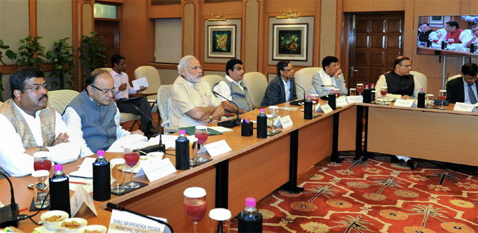 Indian Prime Minister, Narendra Modi (3L) chairs a high-level meeting with industry leaders and top finance bureaucrats on the global economic scenari