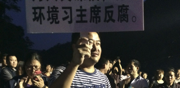 A demonstrator holds a placard during a protest against the construction of a waste incinerator in Hangzhou, Zhejiang province in China.