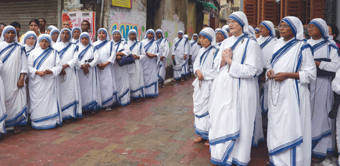 Roman Catholic nuns of the Missionaries of Charity with current Superior General Sister Prema (fifth right) wait to receive the body of Sister Nirmala