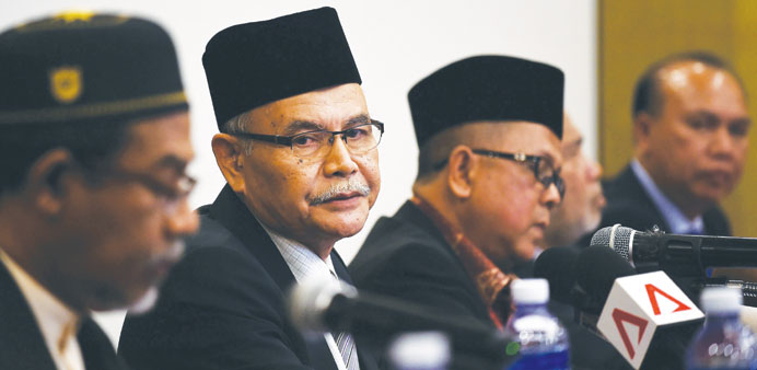 Awang Jabat (second left), chairman of Mara Pattani, the newly founded Muslim rebel group, sits with other representatives as he addresses the media a