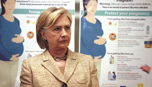 US Democratic presidential nominee Hillary Clinton listens as staff members of Borinquen Health Care Centre speak with her in Miami, Florida, yesterday.
