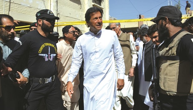 Pakistani cricketer-turned-opposition leader Imran Khan arrives at the site a day after a suicide bombing at the Civil Hospital in Quetta yesterday.