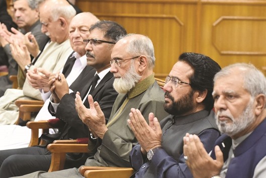 Pakistanu2019s Supreme Court Chief Justice, Anwar Zaheer Jamali (third right) prays alongside others for the victims of the suicide bombing at the Civil Hospital, in Quetta yesterday.