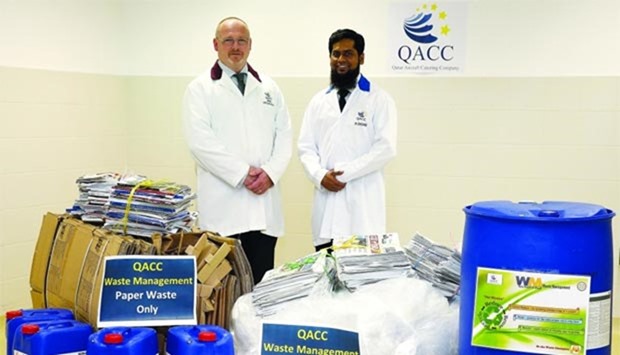 Paul Thomson, acting senior vice-president for Qatar Aircraft Catering Company (left) and Mohamed Shoaib, uniform and linen duty officer at QACC, with some of the materials due to be recycled under the new programme.