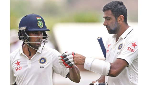Wriddhiman Saha (left) and Ravichandran Ashwin's partnership was worth 213 runs, a new Indian record for the sixth wicket in Tests against the West Indies. (AFP)