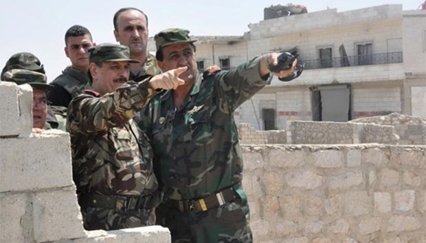 Syrian Defence Minister Fahd Jassem al-Freij (centre) gestures during a visit to regime soldiers in Aleppo this week.