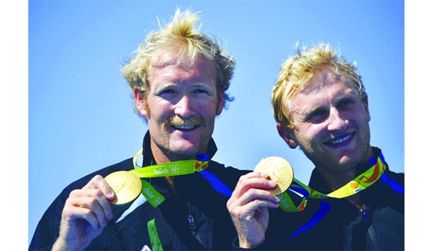 Hamish Bond (right) and Eric Murray of New Zealand with their gold medals after winning the Pair final rowing. (AFP)