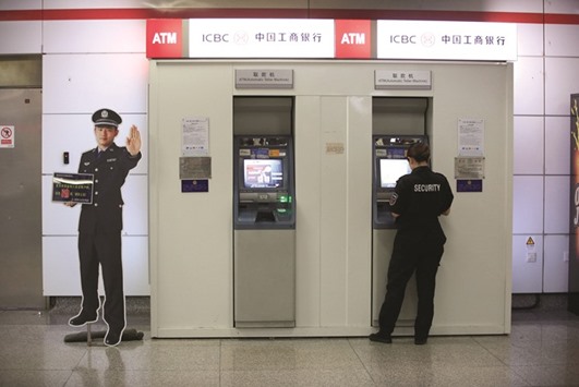 A security guard at an Industrial and Commercial Bank of China ATM at a subway station in Hangzhou, Zhejiang province. The Chinese bank has been an active lender in the Gulf in recent months. It provided a $1.5bn loan to Saudi Electricity Co in June, the same month it agreed to lend $230mn to Emirates National Oil Co.