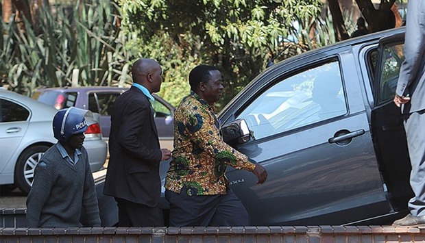 Zimbabwe War Veterans Secretary General Victor Matemadanda is being escorted by Zimbabwean Policemen to a court hearing in Harare after being arrested.