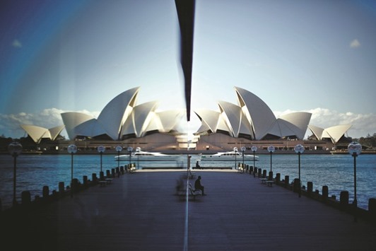 The Sydney Opera House is reflected in a harbourside hotel window in The Rocks district of Sydney.