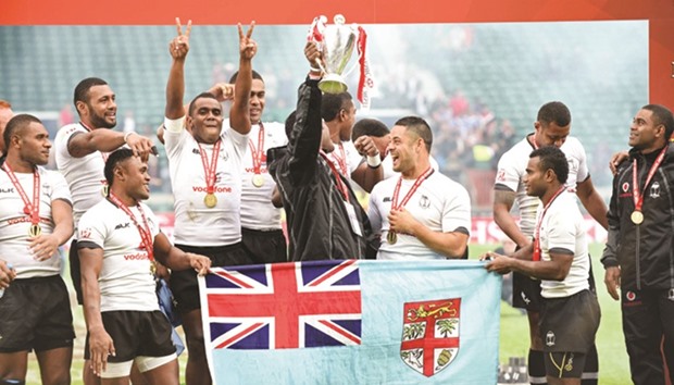 This file photo dated May 23 shows Fiji being crowned Series Champions of the World Rugby Sevens Series at Twickenham in south west London. Fiji have never won Olympic gold but that could change in Rio with a rugby team drawn from the Pacific nationu2019s humble villages which takes the simple approach of training in sand dunes and coral lagoons. (AFP)