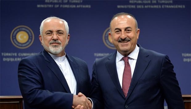 Iranian Foreign Minister Mohammad Javad Zarif (left) shakes hands with his Turkish counterpart Mevlut Cavusoglu after a news conference in Ankara on Friday.