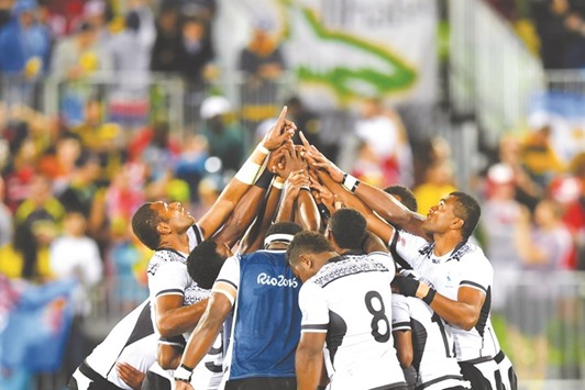 Fijiu2019s players pray after victory in the menu2019s rugby sevens gold medal match between Fiji and Britain at Deodoro Stadium in Rio de Janeiro.