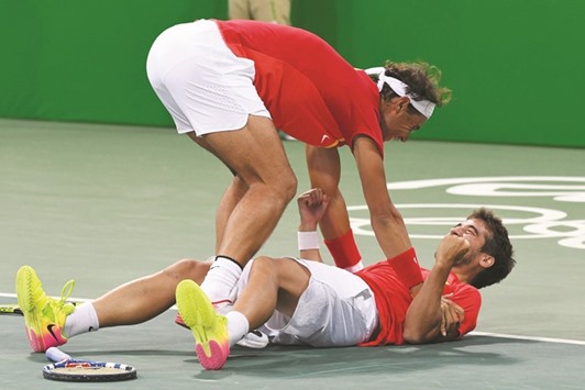 Spainu2019s Rafael Nadal (left) celebrates with doubles teammate Marc Lopez after beating the Canadian pair of Vasek Pospisil and Daniel Nestor to make the final of tennis competition in Rio. (AFP)