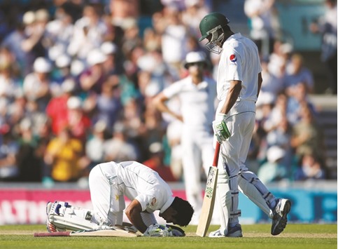 Pakistanu2019s Asad Shafiq celebrates his century as Younis Khan looks on during the third day of the Fourth Test match at the Oval in London yesterday.