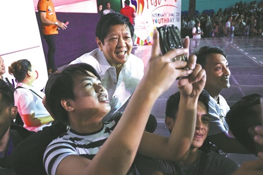 Ferdinand u201cBongbongu201d Marcos Jnr (C top), a former senator and son of the late dictator Ferdinand Marcos, poses for a selfie at a youth gathering at a mall in Manila yesterday. Marcos, who spoke to the media at the event yesterday, said his mother Imelda, the former first lady, will set the date of the burial of his father, after President Rodrigo Duterte on August 7 vowed to push through with the burial of the deposed dictator at the national u201cHeroesu2019 Cemeteryu201d despite threats of protests.