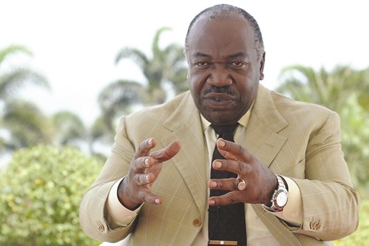 Bongo gestures as he speaks to journalists during an interview in Libreville.
