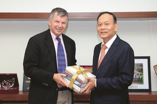 Soonthorn Chaiyindeepum presenting a set of books to Dr James Reardon-Anderson.
