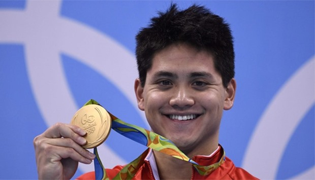 Singapore's Schooling Joseph poses with his gold medal