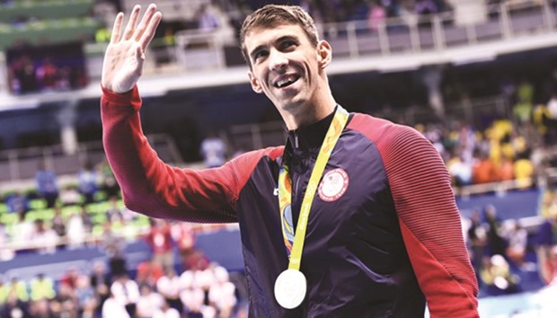 Silver medallist USAu2019s Michael Phelps waves during the medal ceremony of the menu2019s 100m butterfly final.