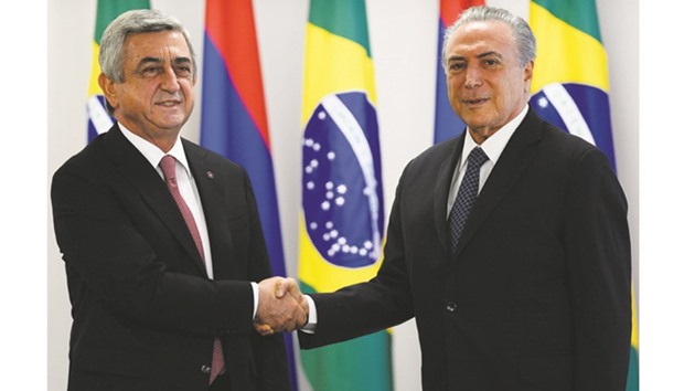 Brazilian acting President Michel Temer (right) welcomes Armenian President Serzh Sargsyan at the Planalto Palace in Brasilia. Sargsyan is the first president to be on visit official after Temer replaced suspended Brazilian president Dilma Rousseff.