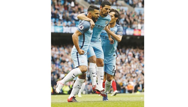 Sergio Aguero celebrates with teammates after scoring the first goal for Manchester City in their Premier League match against Sunderland yesterday. (Reuters)