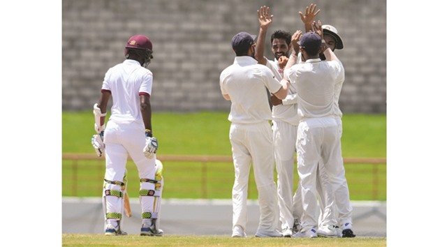 Bhuvneshwar Kumar (3L) of India celebrates the lbw dismissal of Kraigg Brathwaite (L) of West Indies during the 5th and final day of the 3rd Test at Darren Sammy National Cricket Stadium yesterday.