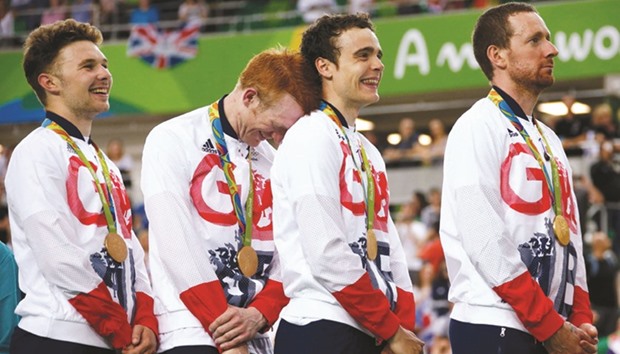 Britainu2019s Owain Doull (from left), Ed Clancy, Steven Burke and Bradley Wiggins on the podium with the gold medals after winning the track cycling team pursuit gold on Friday night. (Reuters)