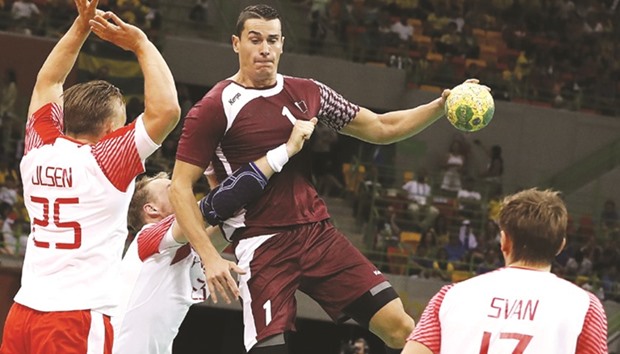 Qataru2019s right back Zarko Markovic (R) vies with Danish players during their menu2019s Group A handball at the Future Arena in Rio de Janeiro yesterday.