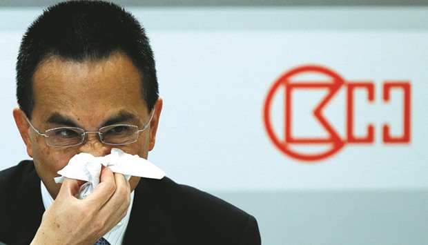 Cheung Kong Infrastructure Holdings chairman Victor Li, elder son of tycoon Li Ka-shing, reacts during a news conference in Hong Kong. Li said the company was looking to expand into non-property businesses outside Hong Kong, without providing concrete details.