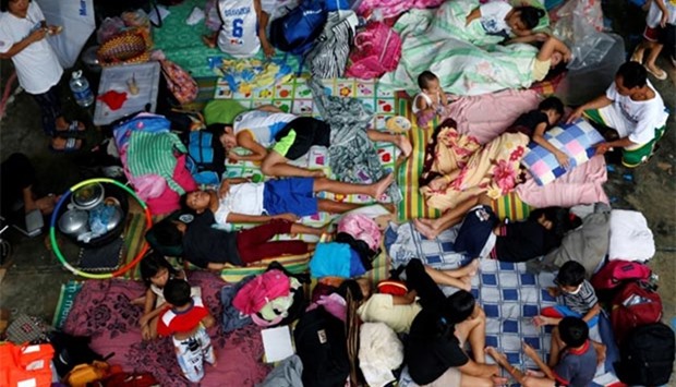 Flood victims take shelter at an evacuation centre after their homes were swamped by floods from monsoon rains in San Mateo, Rizal, Philippines, on Sunday.