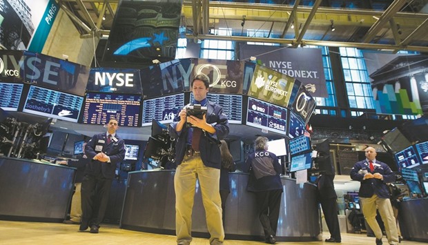 Traders work on the floor of the New York Stock Exchange. The S&P 500 has been stuck in a range of about 40 points since July 8, going 25 days without a move of more than 1% in either direction, the longest such streak since 2014.