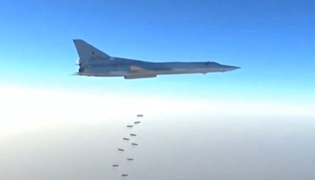 A still image taken from a video footage and released by Russia's Defence Ministry  shows a Russian Tu-22M3 bomber dropping off bombs near what the ministry said is the city of Deir ez-Zor, Syria.