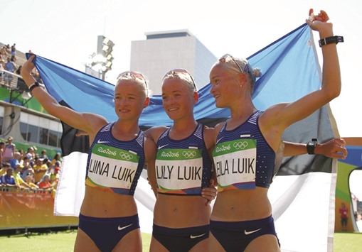 Estoniau2019s triplets Liina, Lily and Leila Luik pose after the marathon in Rio de Janeiro yesterday. (AFP)