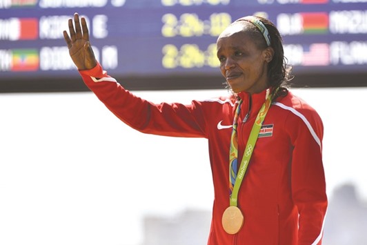 Gold medallist Jemima Jelagat Sumgong of Kenya gets emotional during the podium ceremony for the womenu2019s marathon during Rio 2016 Olympic Games at Sambodromo in Rio de Janeiro. (AFP)