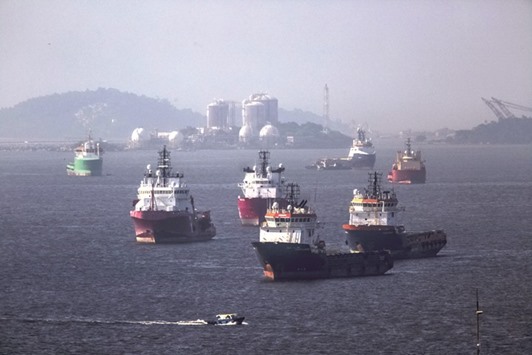 Idle supply vessels float in Guanabara Bay in front of a gas storage facility across from Petrobrasu2019s Comperj oil refinery in Rio de Janeiro, Brazil on April 12, 2016. Petrobras has ended up with four unfinished refinery projects amid the slump in oil prices and a corruption scandal that broke in March 2014 when police arrested a former refining chief, accusing him of involvement in a pay-to-play scheme.