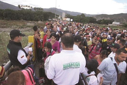 Venezuelans line up to cross the border from San Antonio del Tachira, Venezuela, to Cucuta, Colombia, on Saturday.