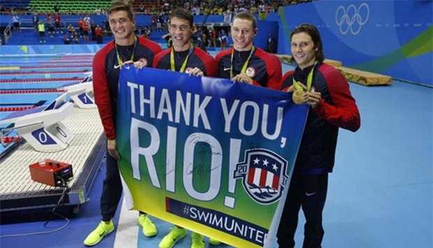 USA's gold medallist team Nathan Adrian, Michael Phelps, Ryan Murphy and Cody Miller pose with a ,Thank You Rio, banner after winning the men's swimming 4x100m medley relay at the Olympic Aquatics Stadium in Rio de Janeiro on Saturday.