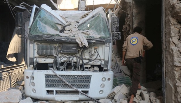 A civil defence member inspects the damage after their centre was hit by an airstrike