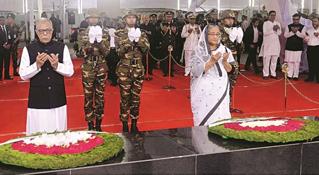 President Abdul Hamid and Prime Minister Sheikh Hasina pray before the portrait of Bangladeshu2019s founding father Bangabandhu Sheikh Mujibur Rahman in Dhaka, on the occasion of the National Mourning Day yesterday.