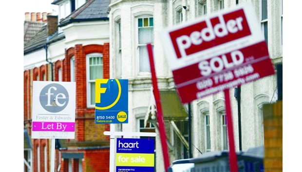 Estate agents boards lined up outside houses in south London.