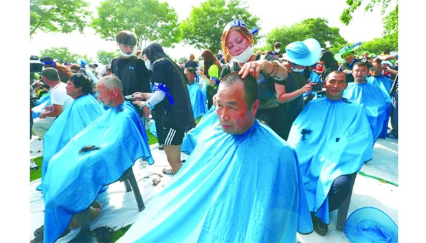 DONu2019T WANT THAAD: More than 900 Seongju residents have their heads shaved during a protest at a local park in the southeastern town of Seongju against the planned deployment of the THAAD system.